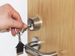 Kädessä avain, jota ollaan laittamassa oven lukkoon. Kuva susanna hult